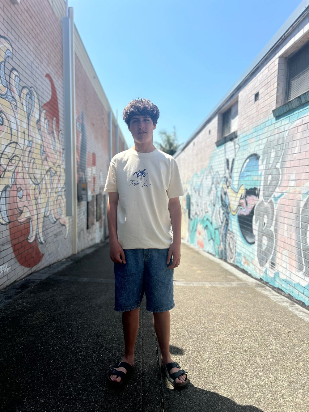 Male model wearing natural heavyweight palm print tee showing design front